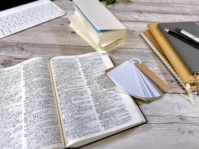 辞書とカードが並ぶ勉強の場面